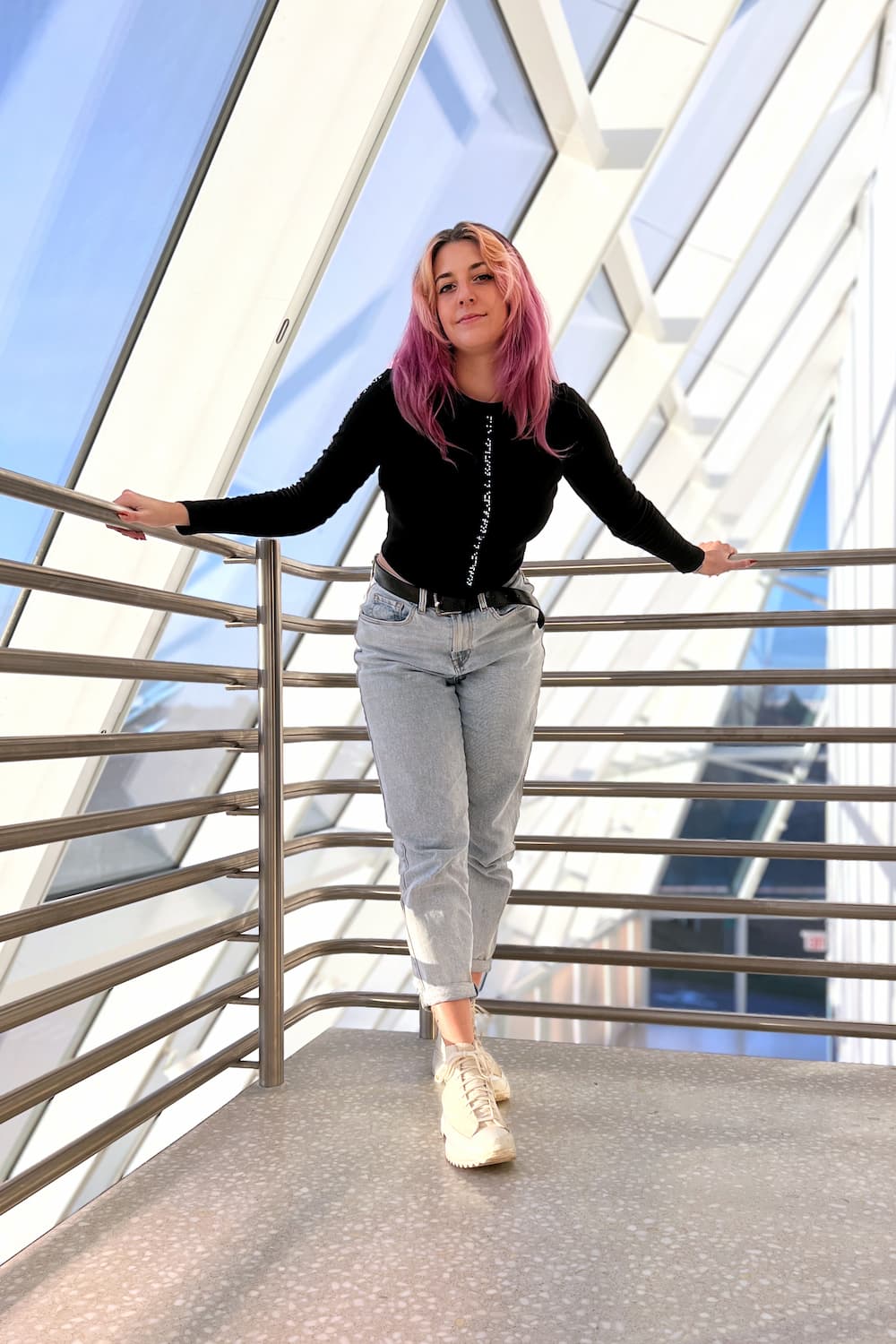 Full body outfit featuring cropped braille long sleeve and light wash mom jeans
