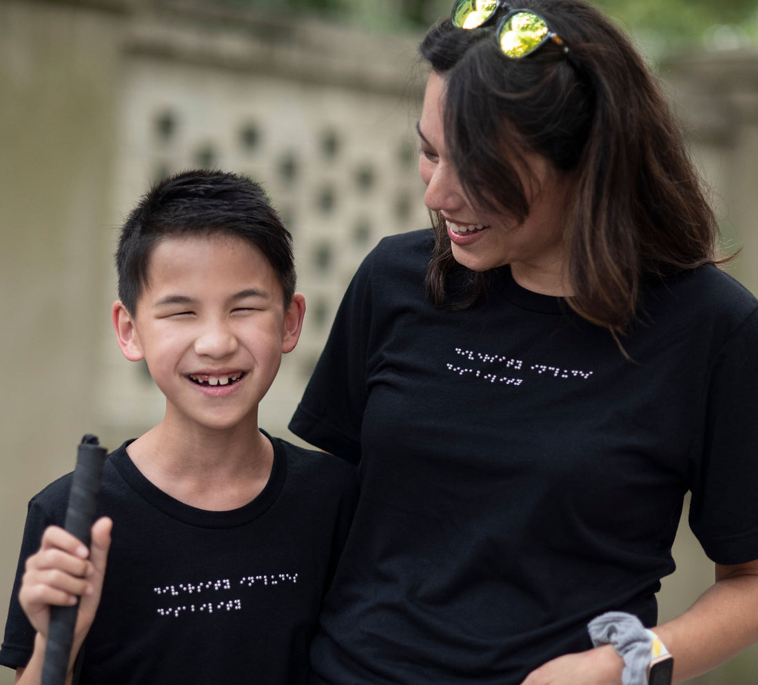 Mom and blind son wear custom matching braille t-shirts
