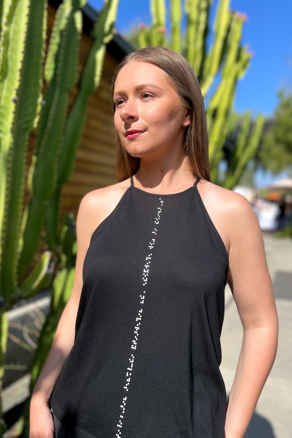 High neck black tank top with white braille beadwork down the center front