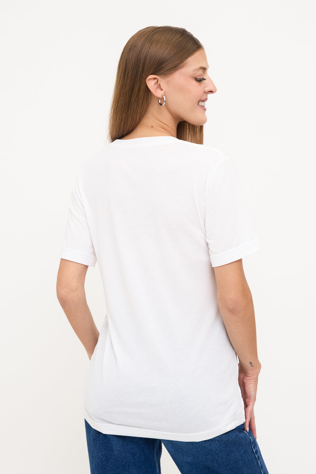 Back View of Woman's White T-Shirt: Back view of a young blind woman with long straight hair, wearing a white t-shirt.