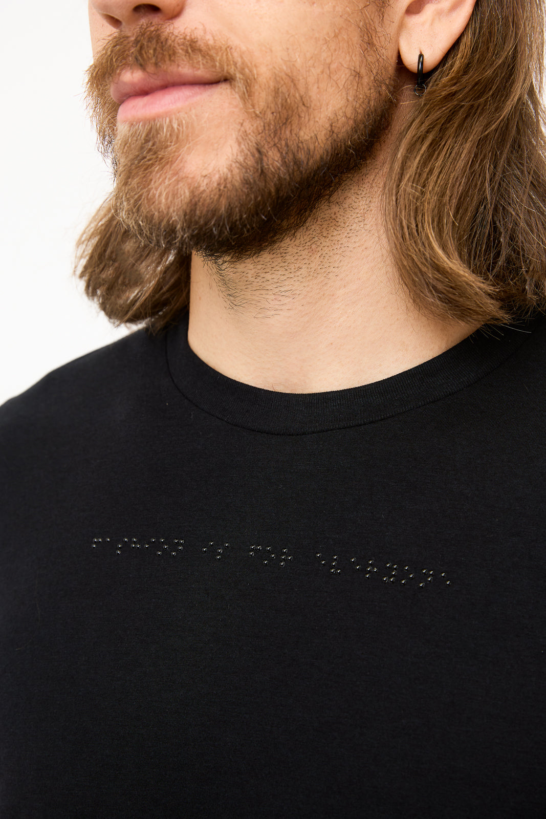 Braille Detail on Black T-Shirt: Close-up of black braille beadwork on shirt reads "fashion is for everyone".