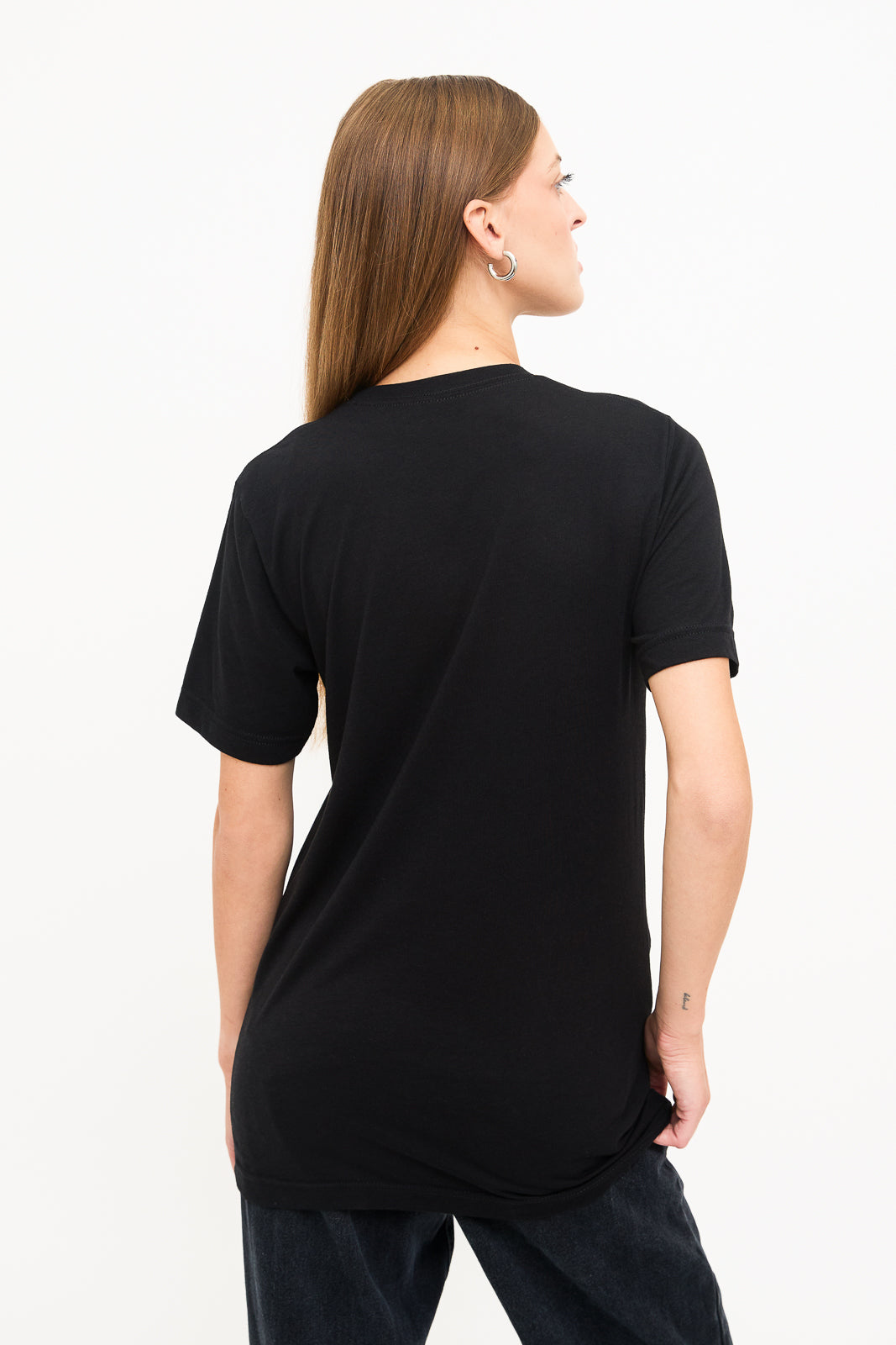 Back View of Woman's Black T-Shirt: Back view of a young blind woman with long straight hair, wearing a black t-shirt.