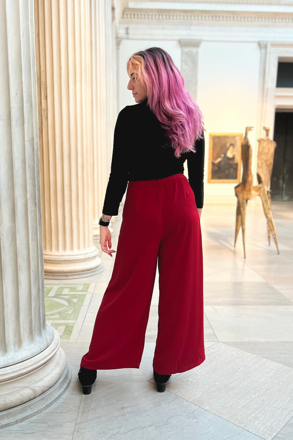 Back view of model wearing red wide leg pants