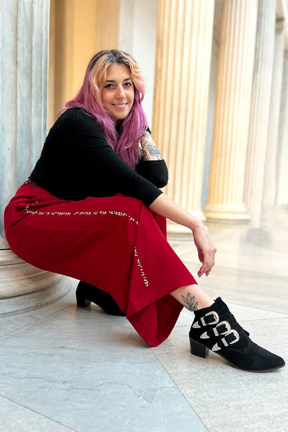 Model sitting and showcasing braille on pant leg