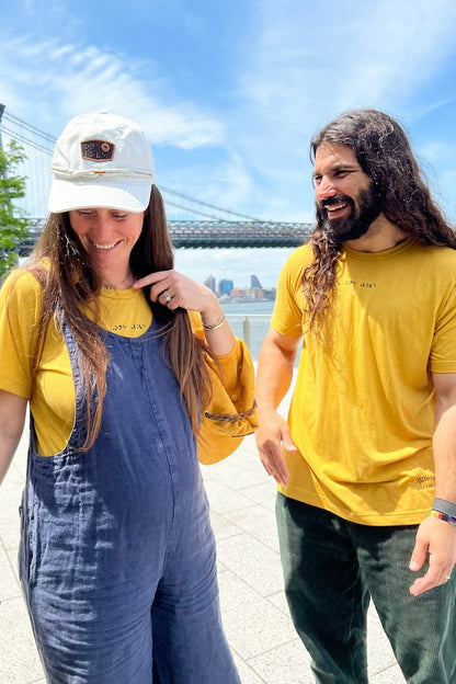 Kelly and Anthony Ferraro smile at each other while wearing matching yellow braille shirts