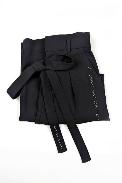 Folded black pants with fabric tie belt