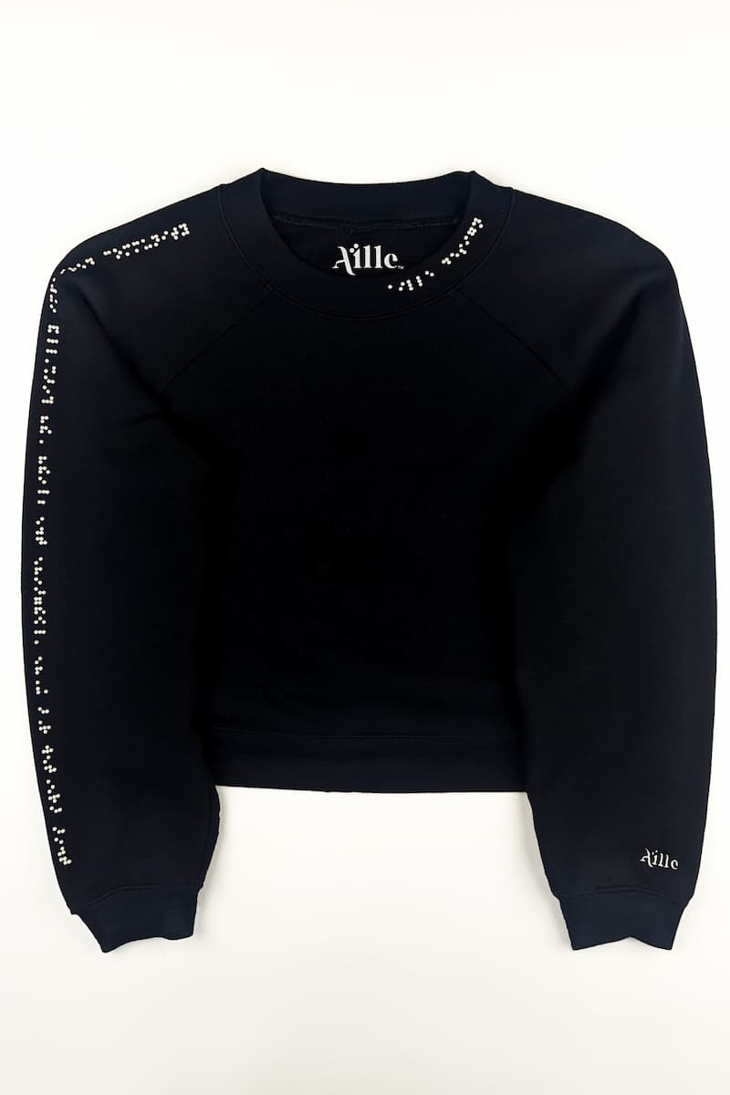 Black cropped sweater with white braille