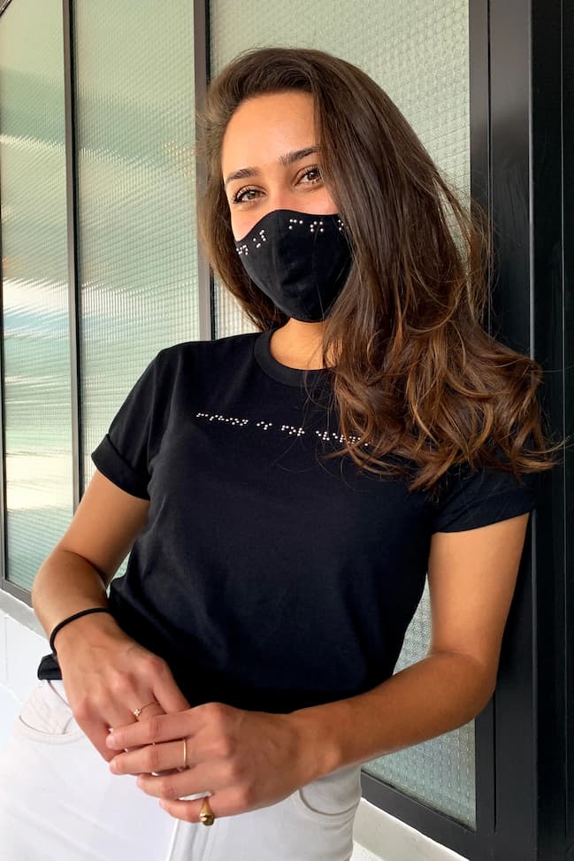 Close up of young Indian woman wearing black braille t-shirt and black braille mask