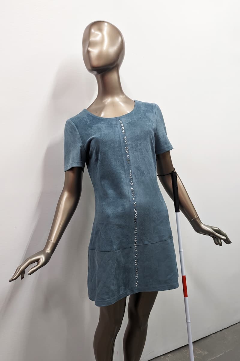 Mannequin with braille clothing dress and white cane