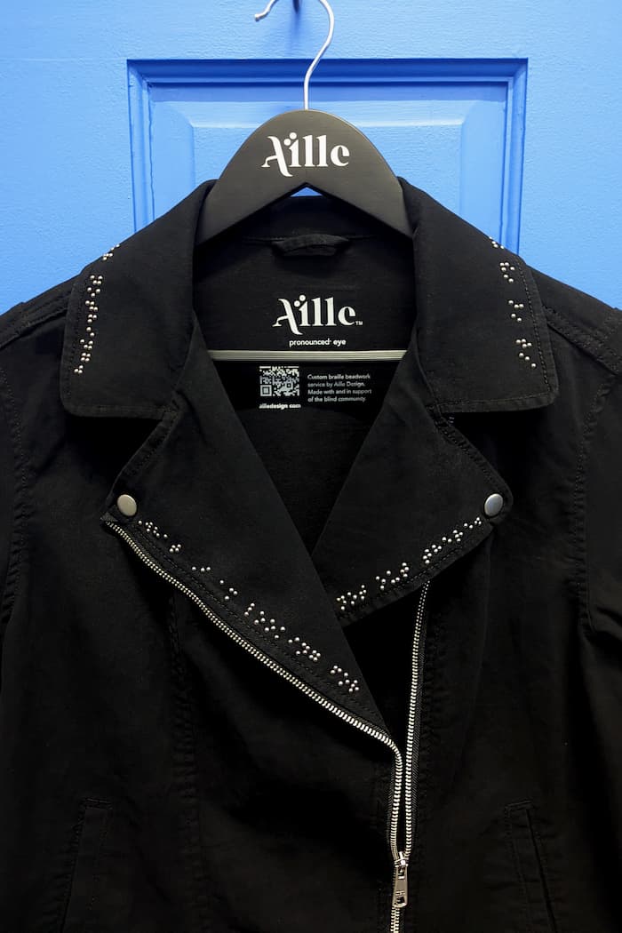 Black denim motto jacket clothing with braille
