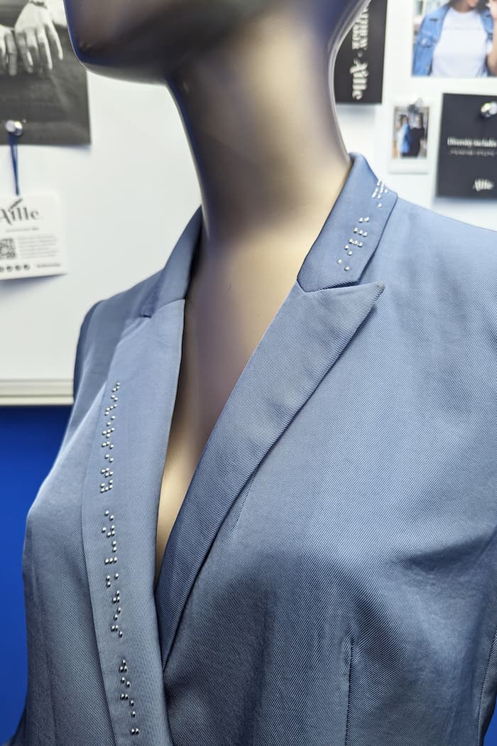 Detail photo of braille on blue blazer dress