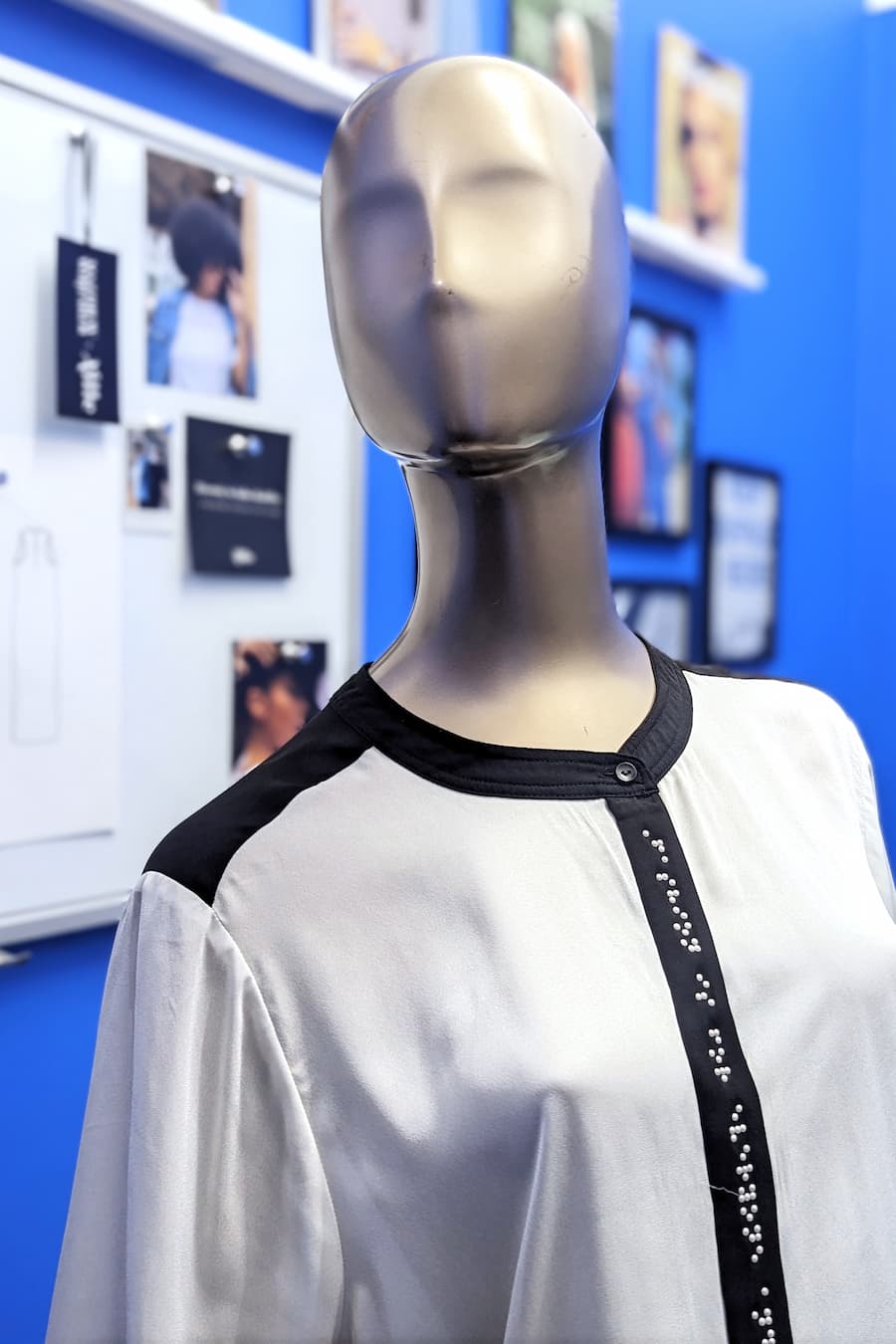 Close up of mannequin wearing black and white braille blouse