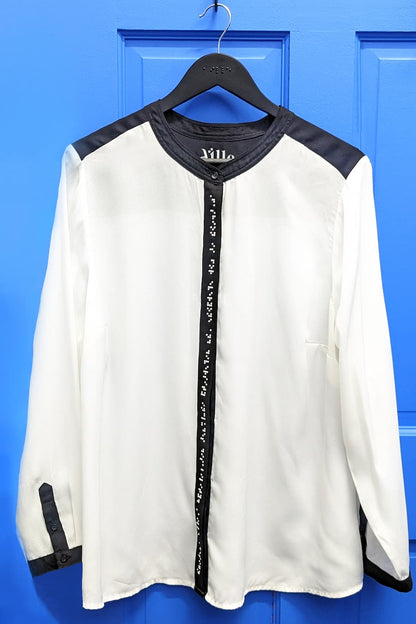Black and white braille blouse on blue background