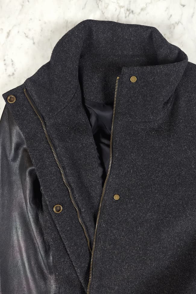 Detail photo of zipper and snap closures on front of coat